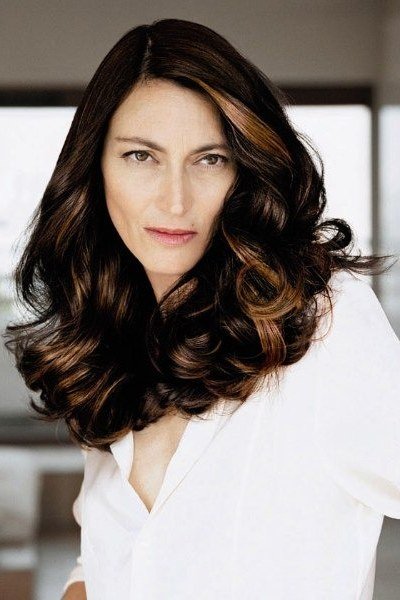 Long dark-brown voluminous curls for women over 50