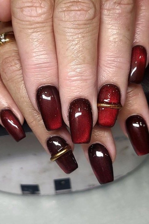 Deep Oxblood Nails with Gold Bands for women over 60