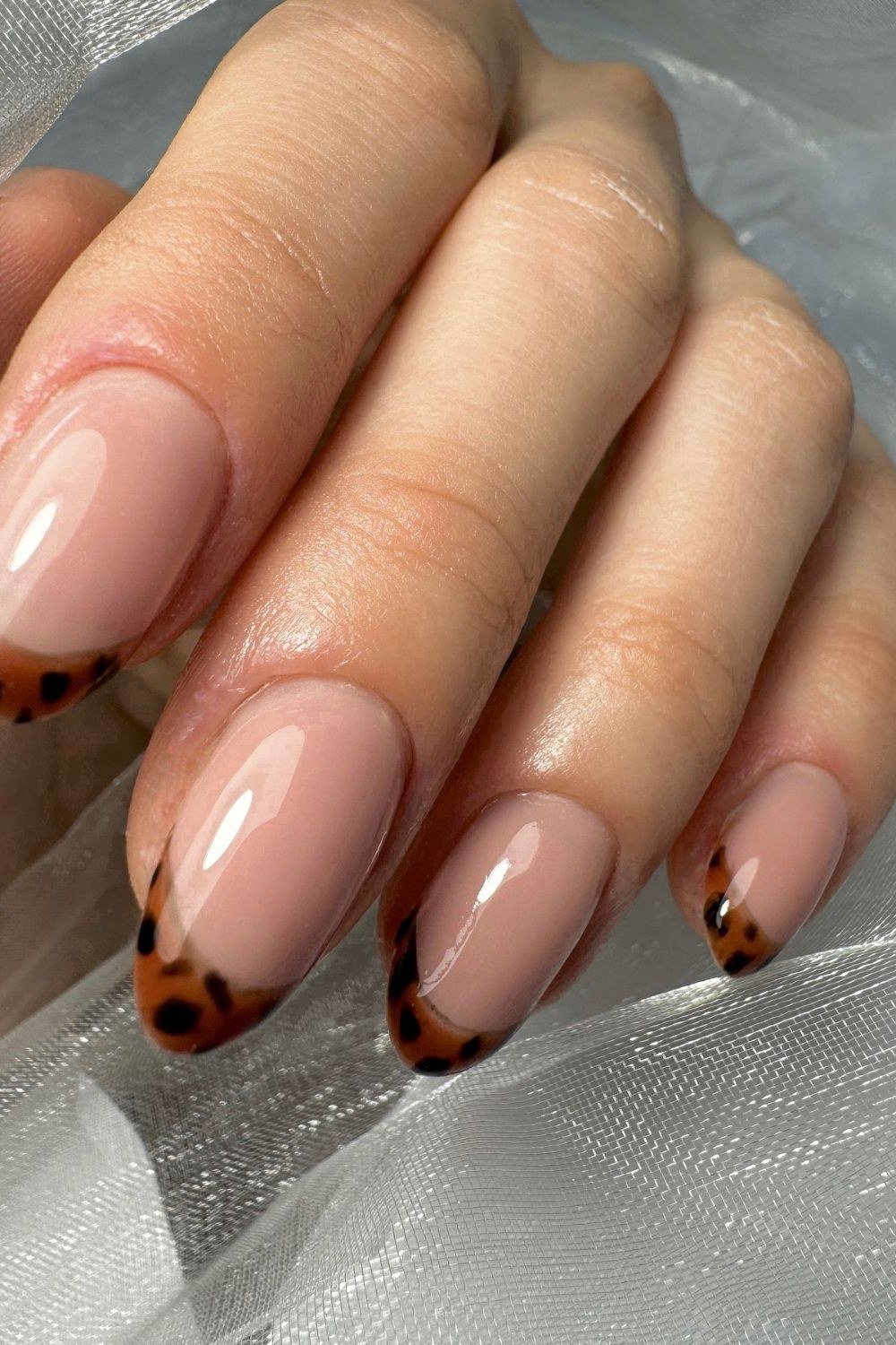 Nude nails with tortoiseshell pattern french tip manicure