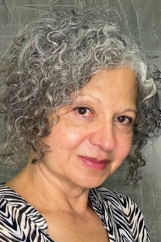 Silver-gray defined curly lob, front view, mature woman