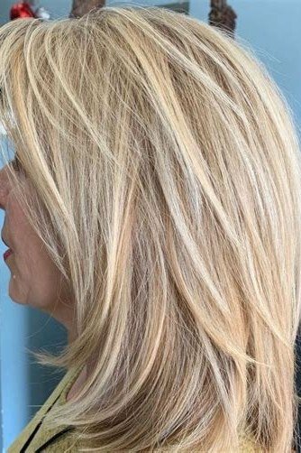 blonde layered medium straight hairstyle, side view for women over 50