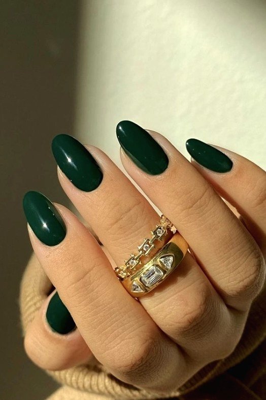 Solid emerald green almond nails with gold rings - Christmas nail design for older women