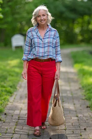 Easy casual outfit idea for women over 50: plaid shirt with red cropped pants, older woman everyday style