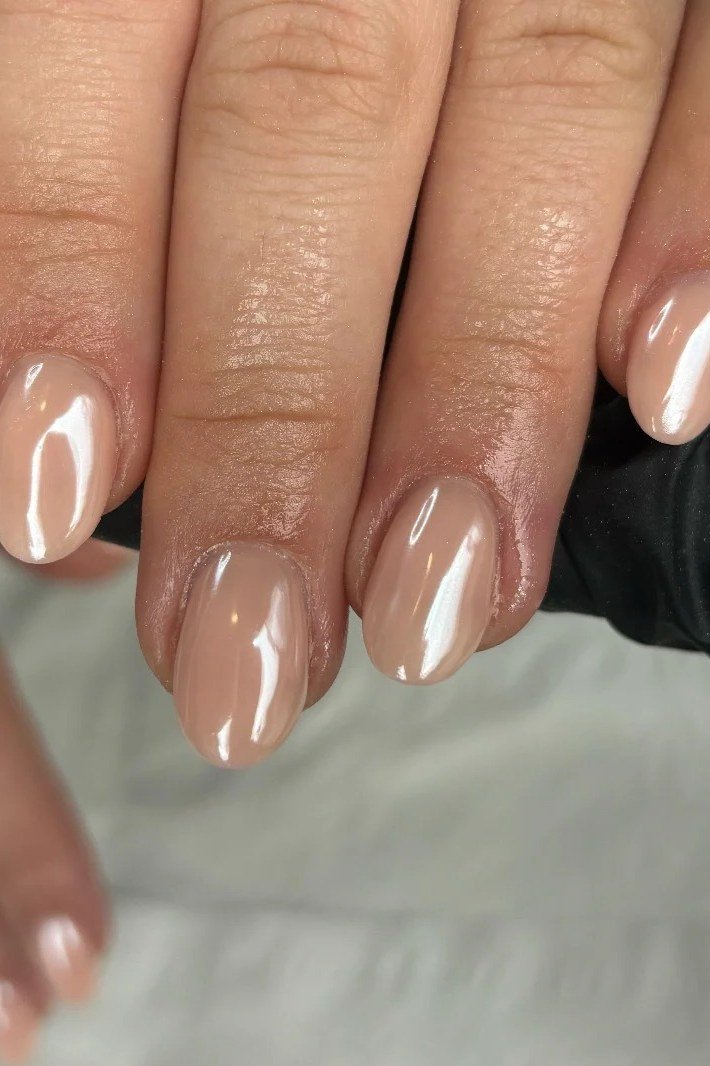 Glossy Pearl Nude Short Oval - elegant nude nail design for women over 60