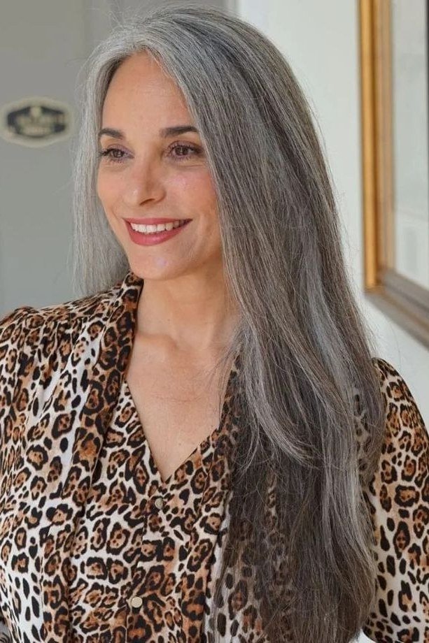Long silver-gray straight layered hair with center part for women over 50