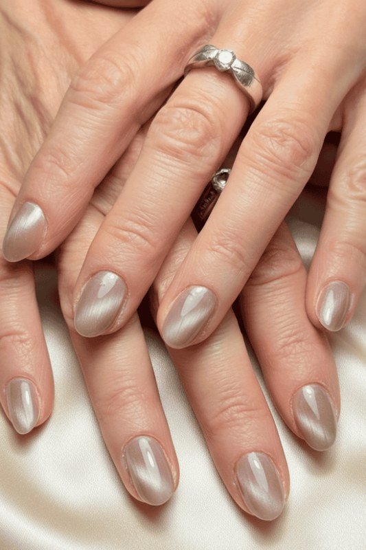 Pearl White Cat Eye Nails - Soft pearl white with a gentle magnetic glow covers these medium length oval nails.