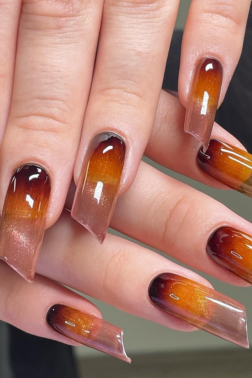 Sunset Ombre Coffin Nails with Black Tips - A glowing amber and copper ombre covers these long coffin nails, finished with deep black tips.