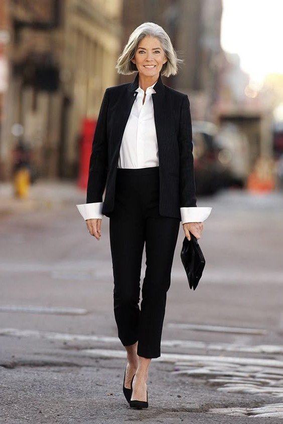 Work outfit for women over 40: black blazer with white shirt cuffs showing