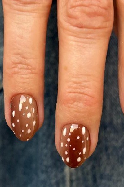Almond nails burnt orange with white fawn spots front view fall nails