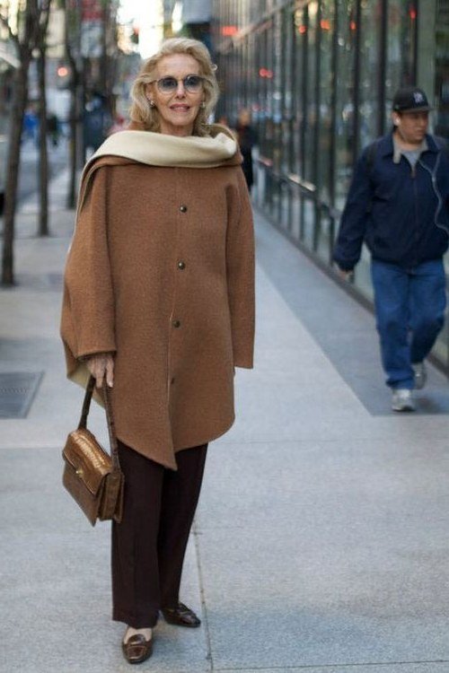 brown wrap coat with dark trousers and tan bag for women over 50