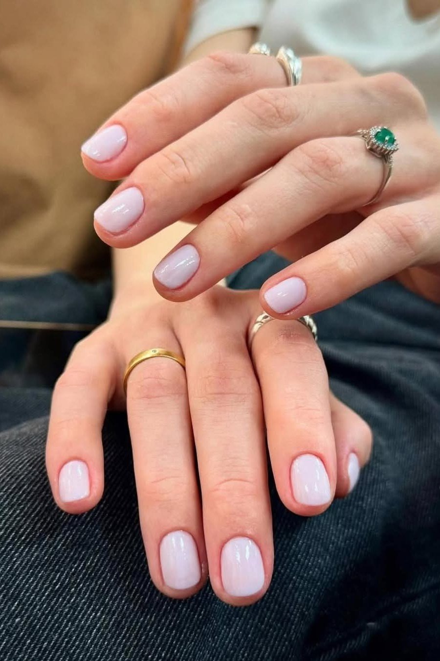 Milky pink short almond nails with rings, sophisticated nail design for women over 50