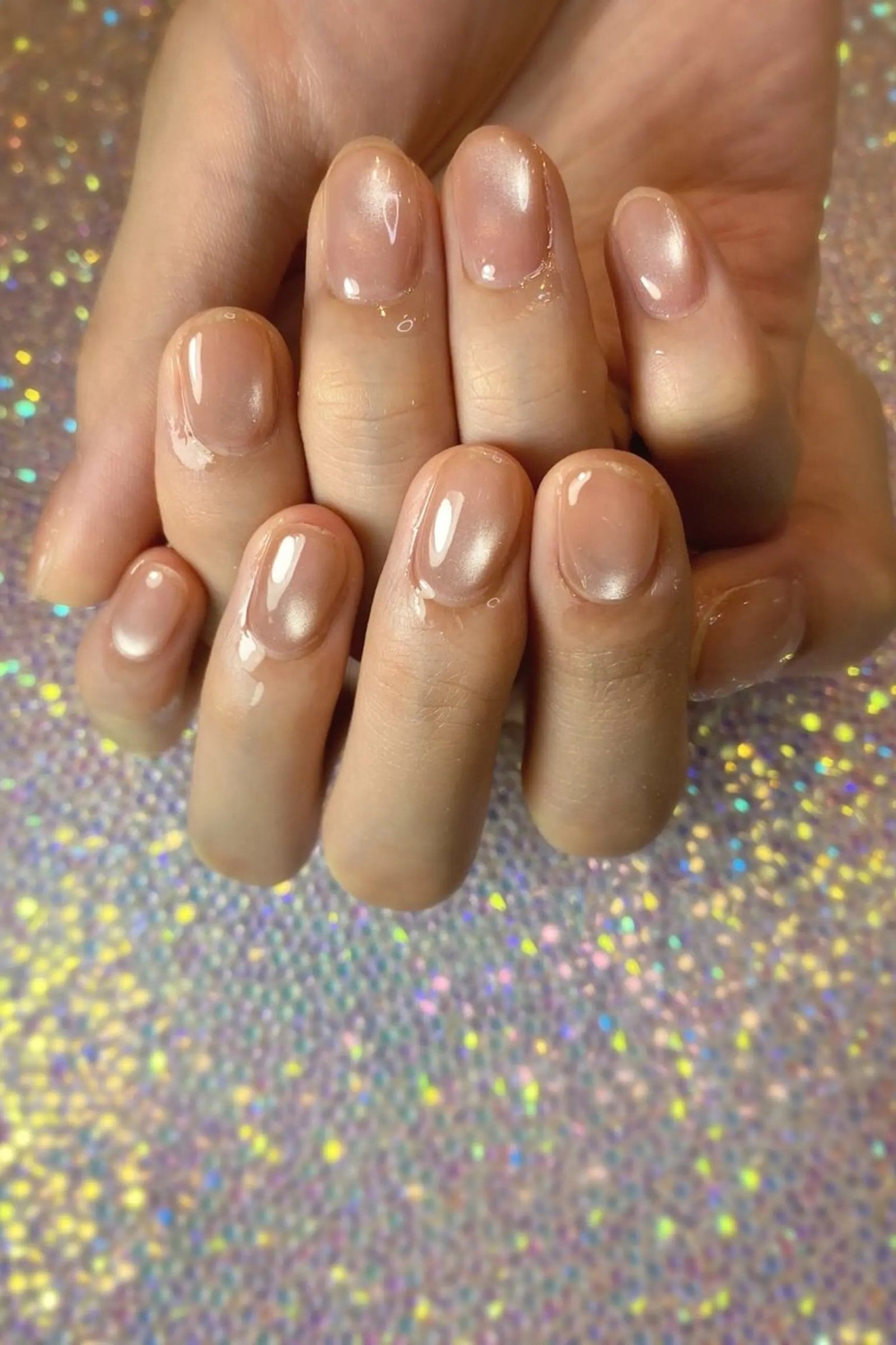 Sheer Nude on Glitter Background - elegant nude nail design for women over 60