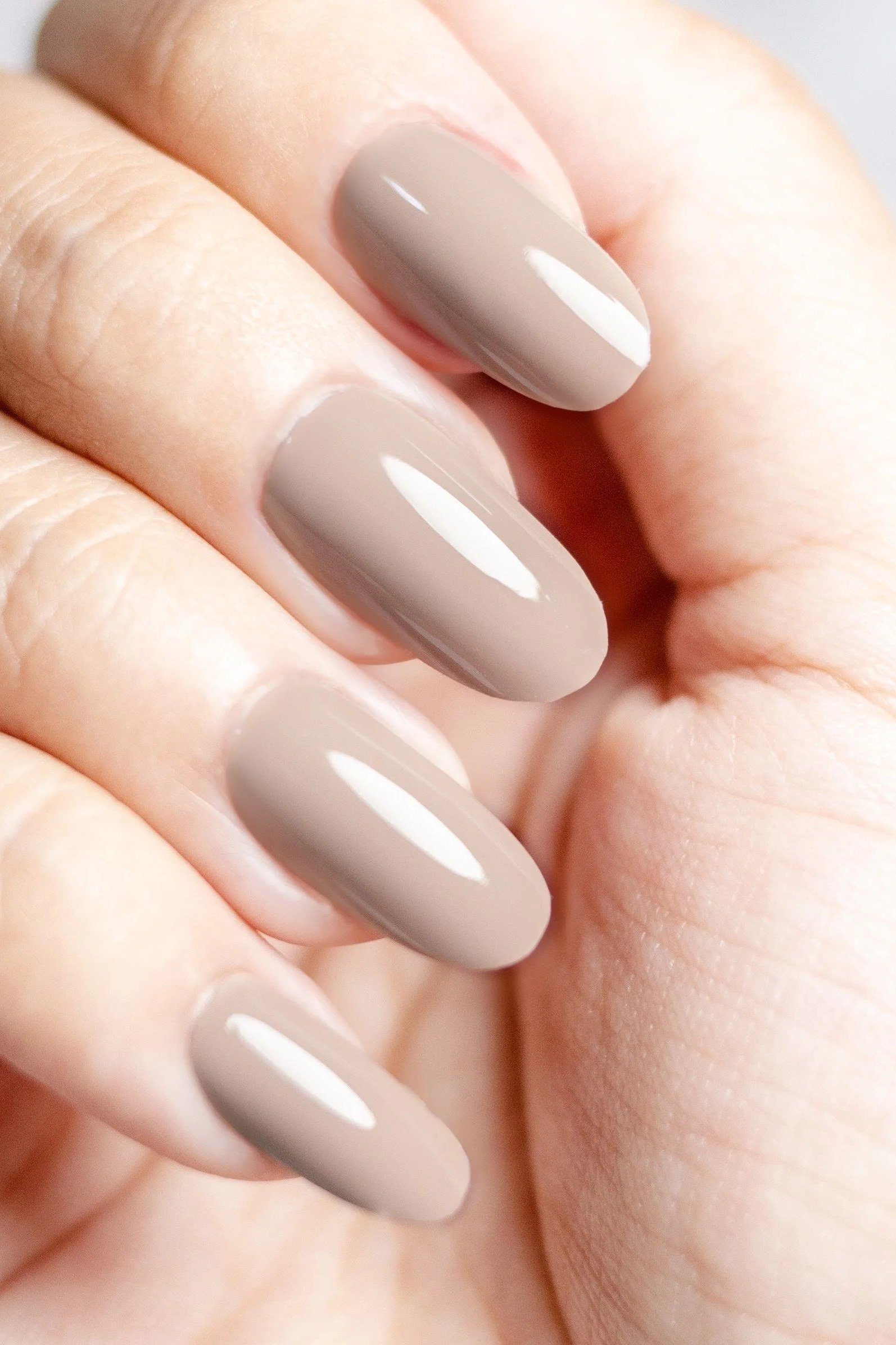Glossy Taupe Almond Nails on White - brown nail idea for women over 50