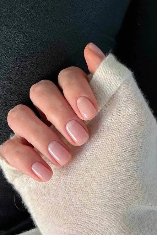 Glossy Pink Nude with a White Knit Cuff - short nude nail idea for women over 50