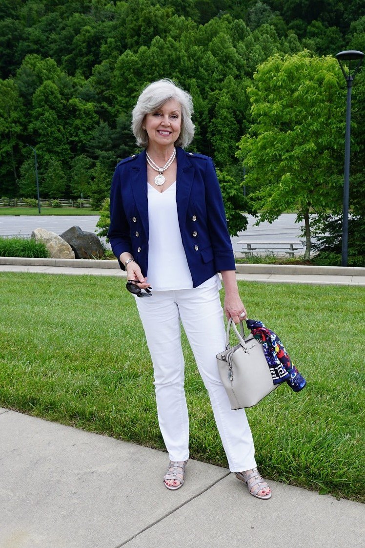 Woman over 50 wearing navy blazer with white jeans, everyday casual outfit idea