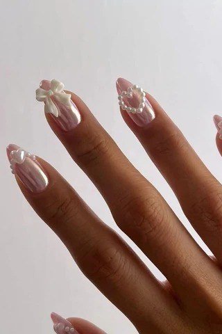 Oval strawberry pink chrome nails with bow art