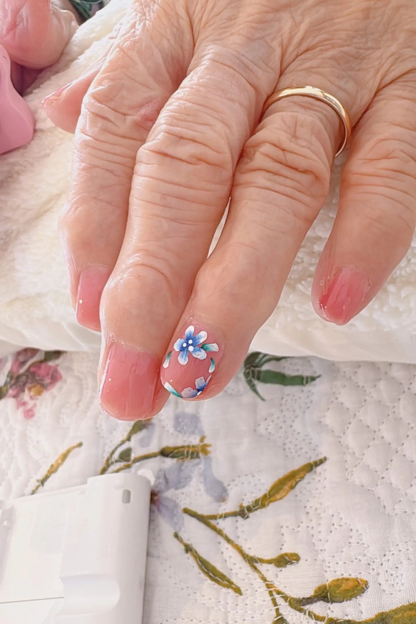 Pink nails with blue floral accent nail