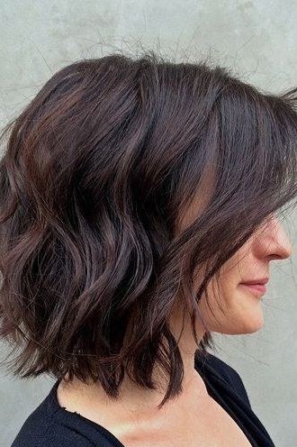 Dark brown shaggy bob haircut profile for older women