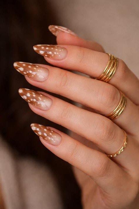Almond nails caramel with white spotted tips and gold rings
