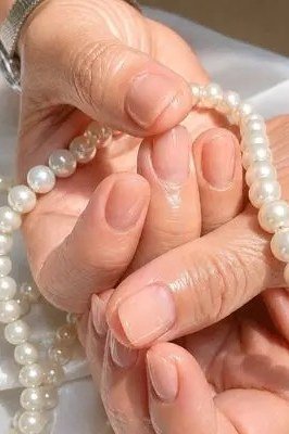 nude short oval, pearl bracelet - winter nail trend for older women
