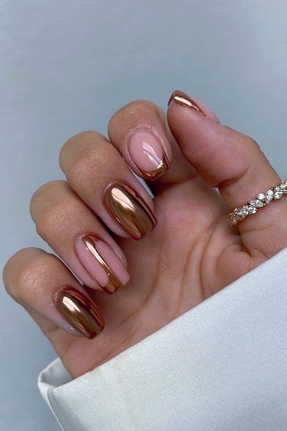 Rose gold chrome metallic, almond shape, medium length, glossy, fall nail color for women over 40