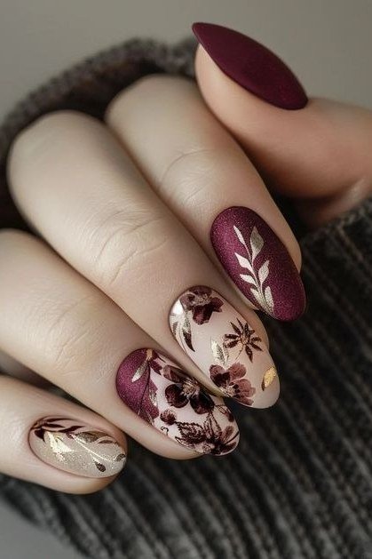 Burgundy almond nails with gold leaf floral accent for women over 50