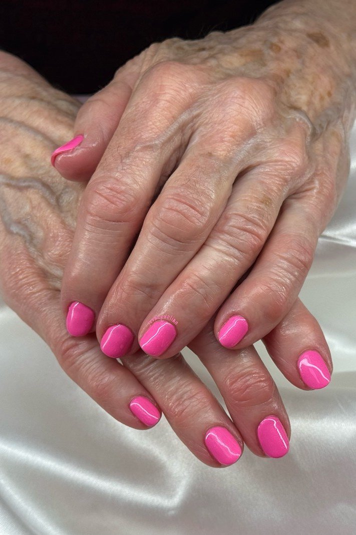 Hot pink nails on older hands, best manicure idea for women over 60