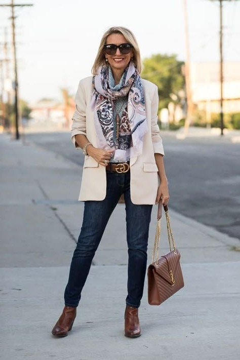 Cream blazer with floral scarf jeans and brown boots for women over 60