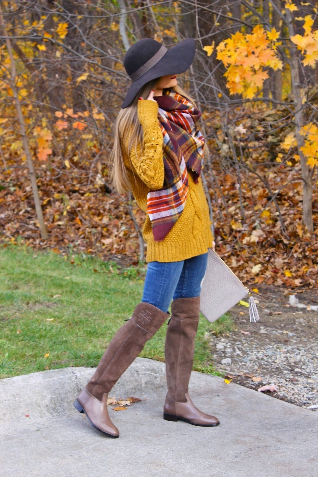 Mustard cable knit sweater with plaid scarf jeans and knee boots, fall outfit for women over 40