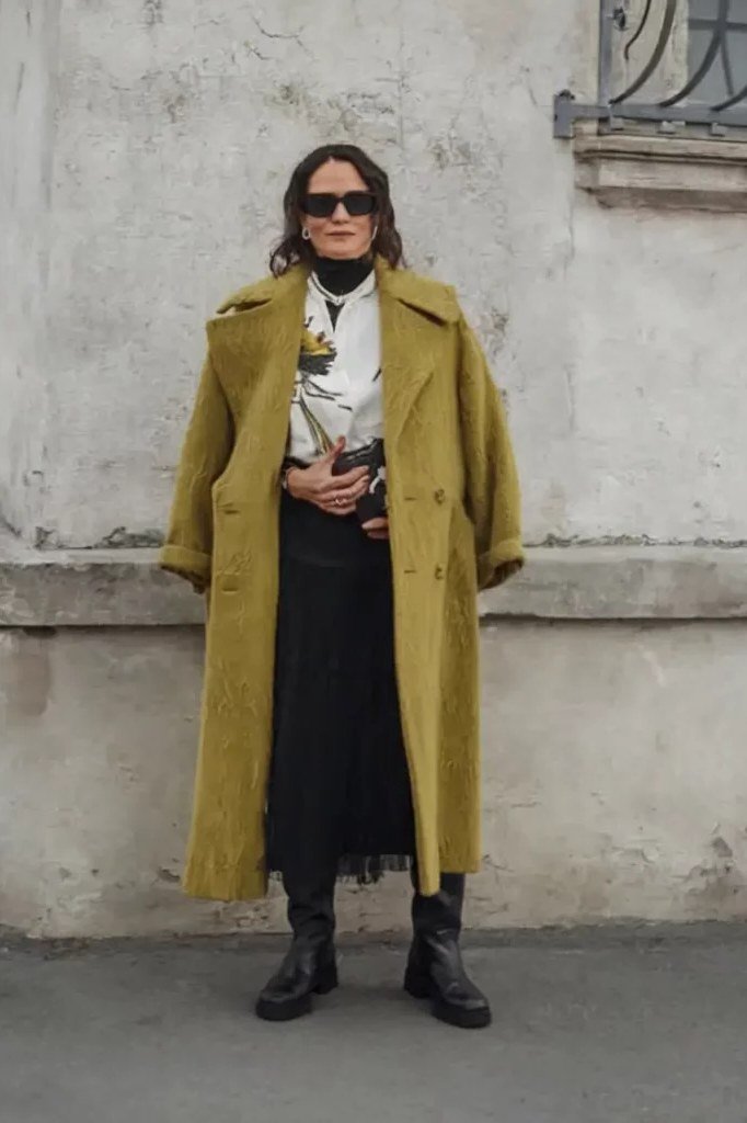 chartreuse coat over a black dress fall outfit for women over 60