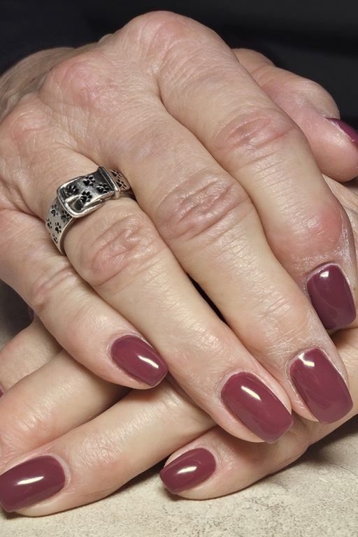 Deep Plum Squoval Nails on Mature Hands - old money fall nail color for women over 40