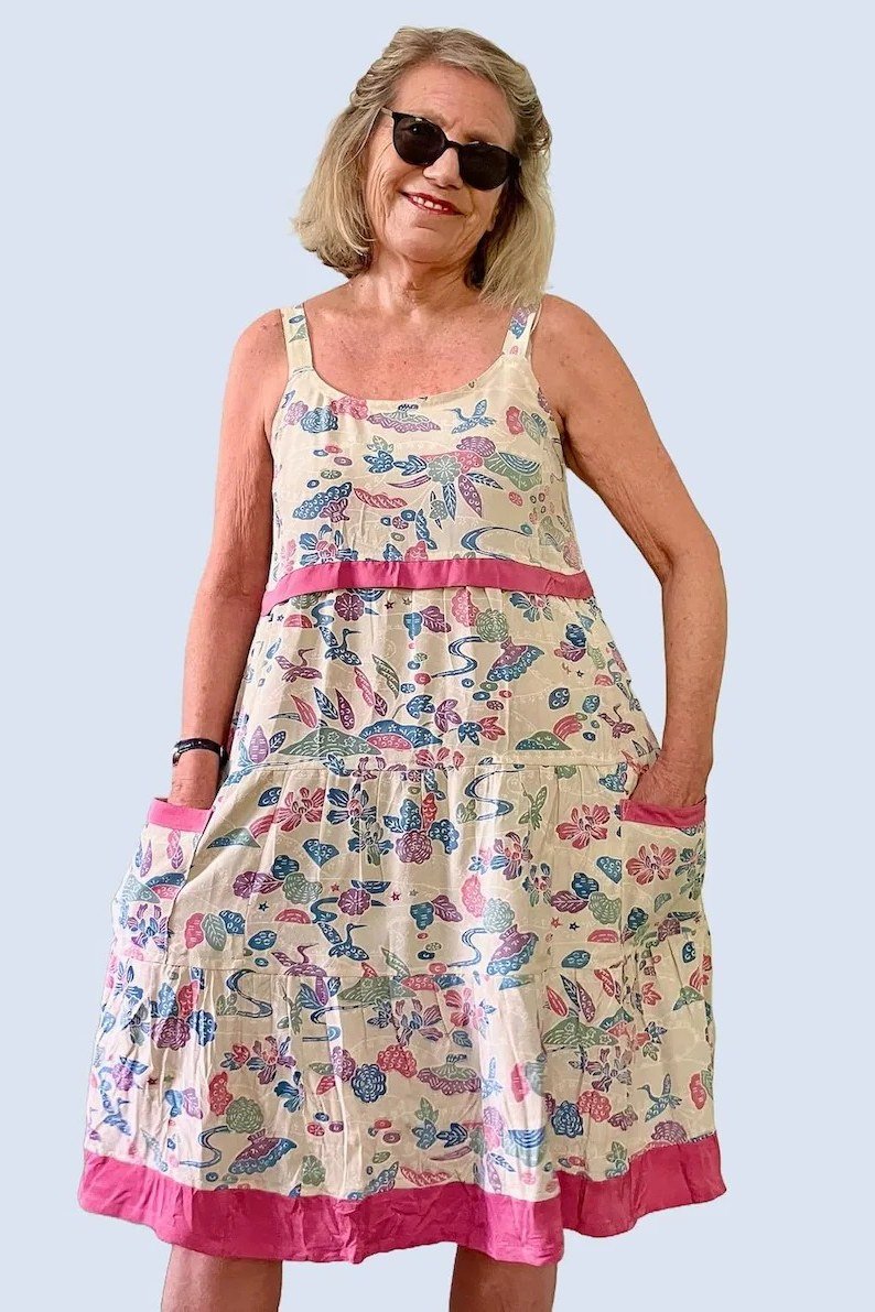 Breezy summer dress for women over 60: black dress with big orange blooms