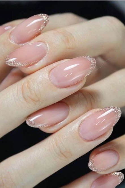 sheer pink almond nails with glitter outline tips