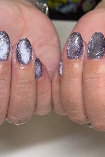 Icy Blue Silver Cat Eye Nails - Cool icy blue with silver magnetic shimmer covers these short, oval nails.