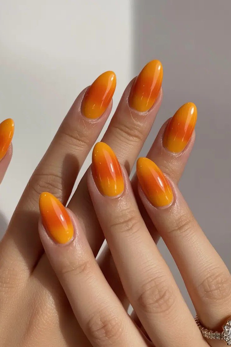 Warm Orange Gradient Almond Ombre - Bright tangerine fades into soft peach on these medium almond nails.