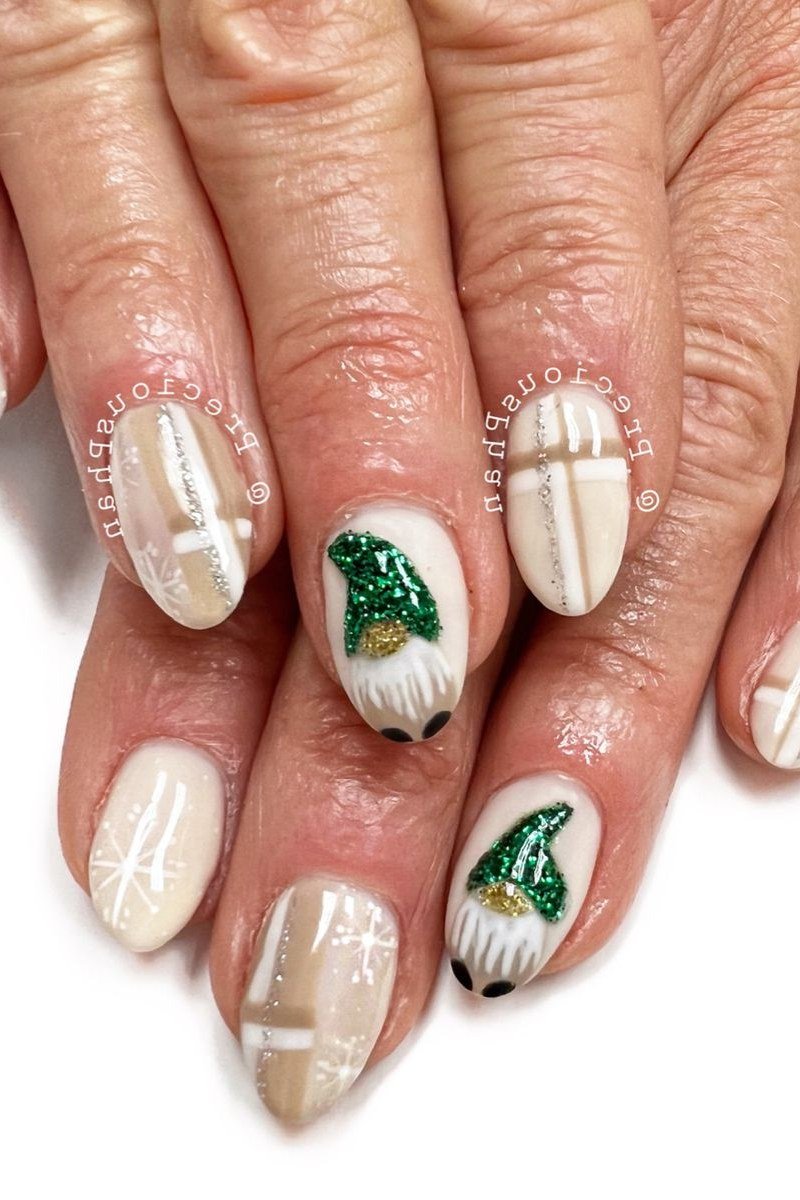 White with green Christmas gnome and snowflake art, mature hands - Christmas nail design for older women