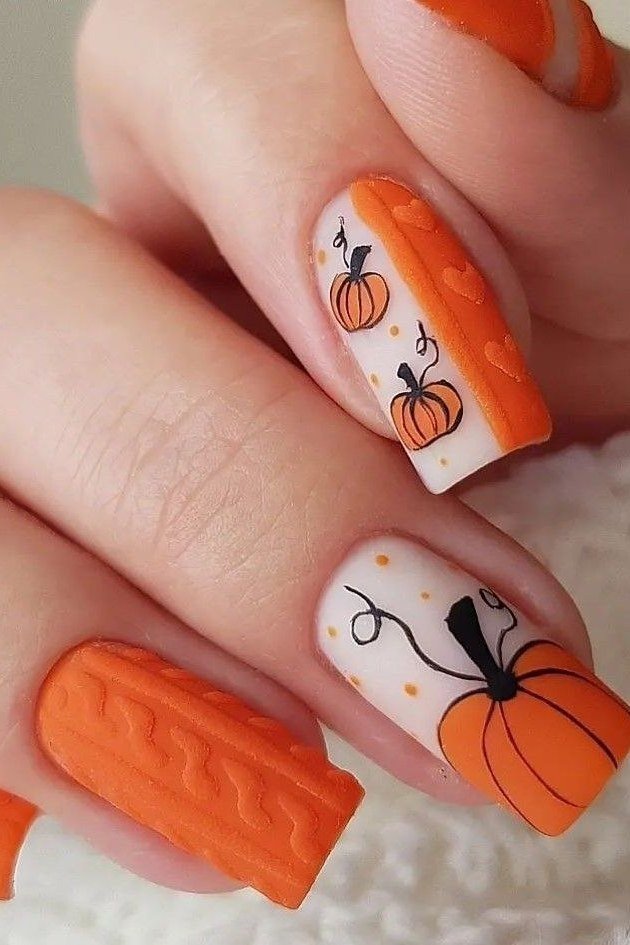 Bright pumpkin nail art on orange nails, fall nail design for older women