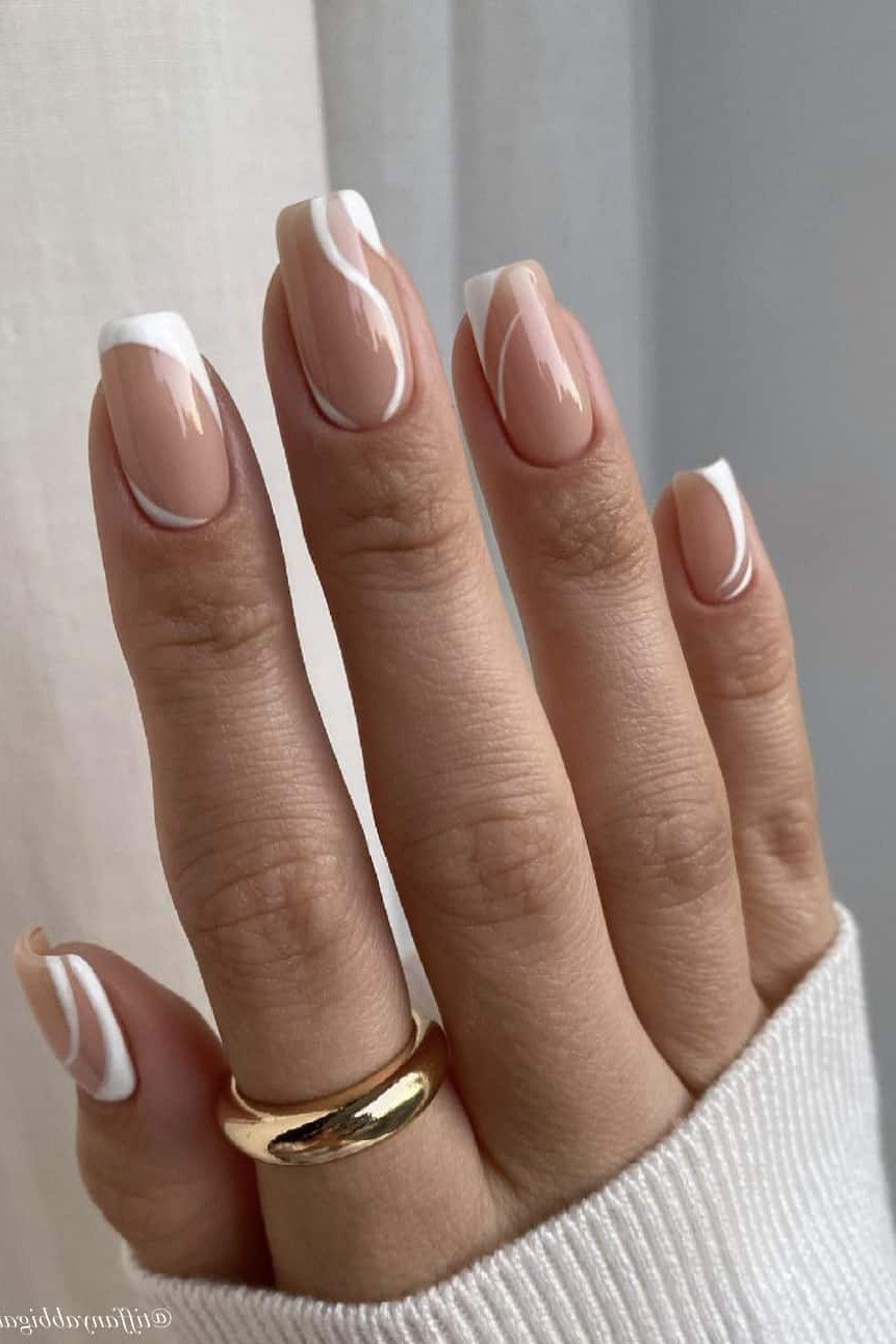 Nude nails with white swirl french tips and gold ring for women over 70