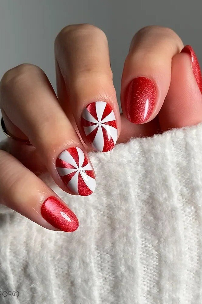 red christmas nails with peppermint swirl accent nails