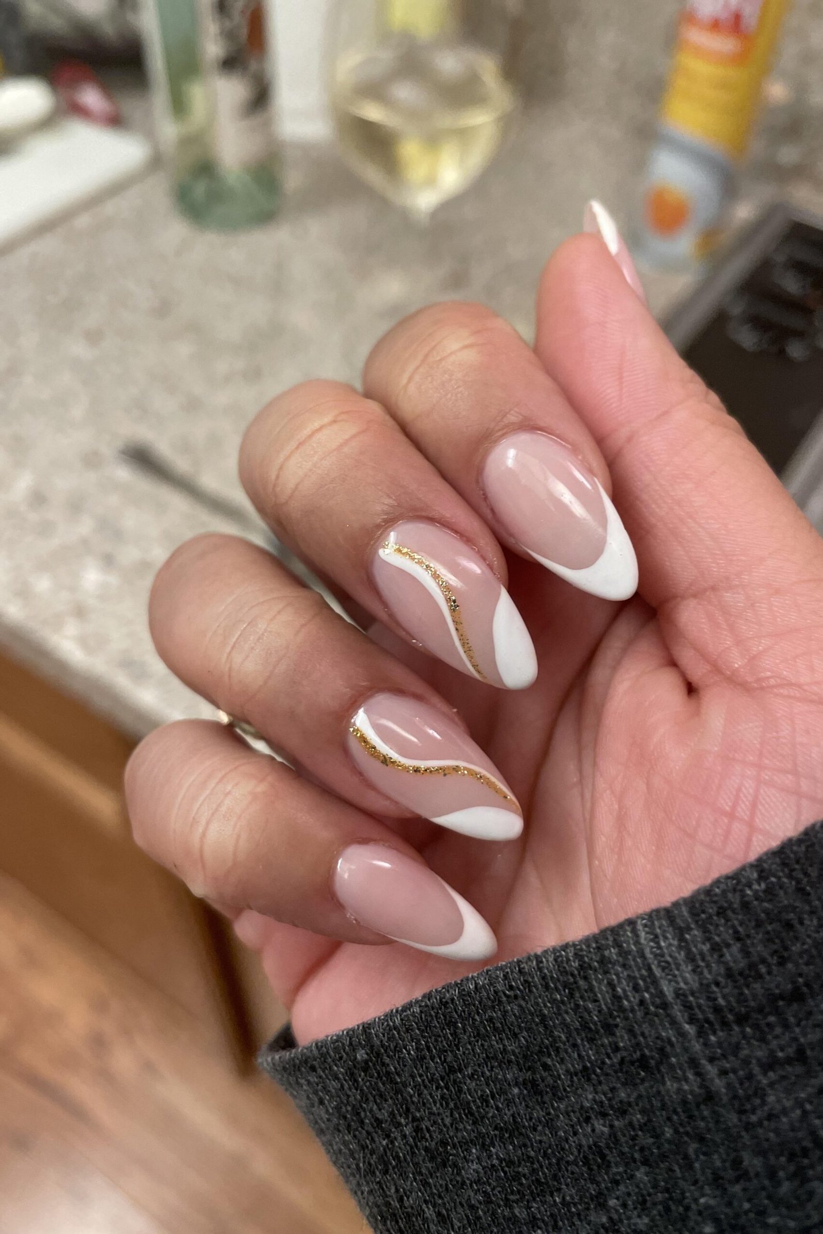Best nails for women over 50: french with gold swirl