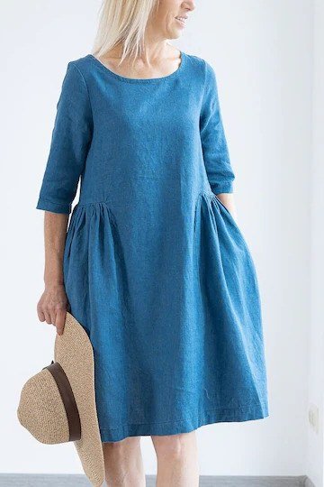 Cobalt blue midi dress with straw hat, bright interior for women over 60