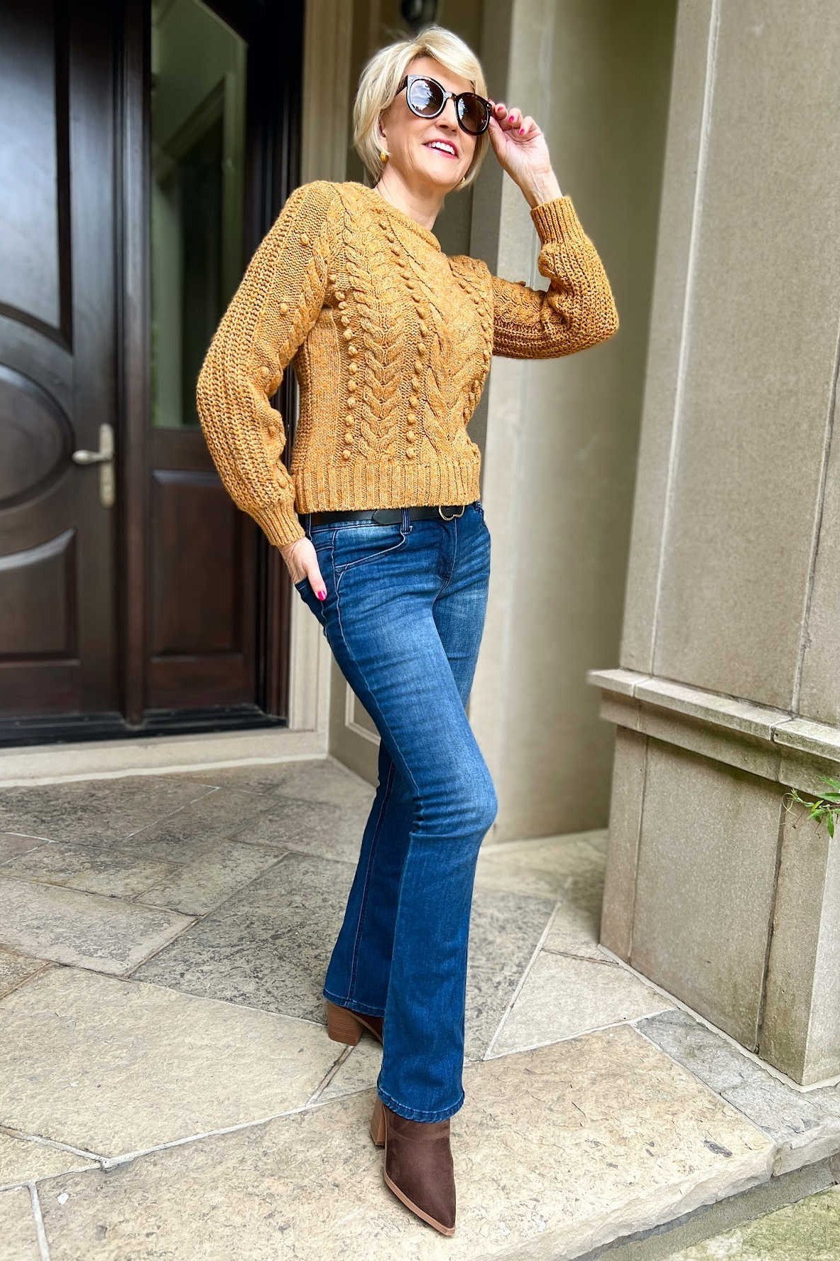 mustard cable knit sweater dark flare jeans brown pointed boots women over 50
