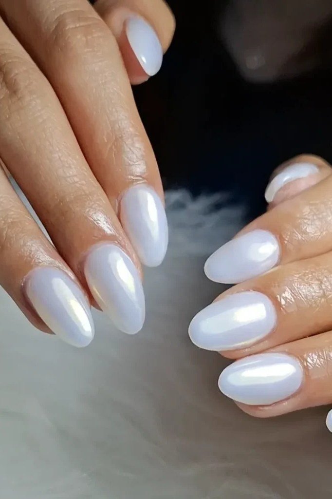 Pearl chrome milky white manicure on both hands