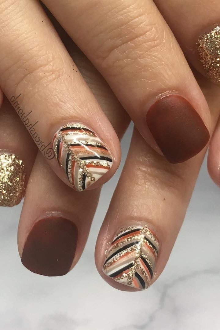 26. Matte Chocolate Nails With Gold Glitter Leaves - Thanksgiving nail art idea for women over 50