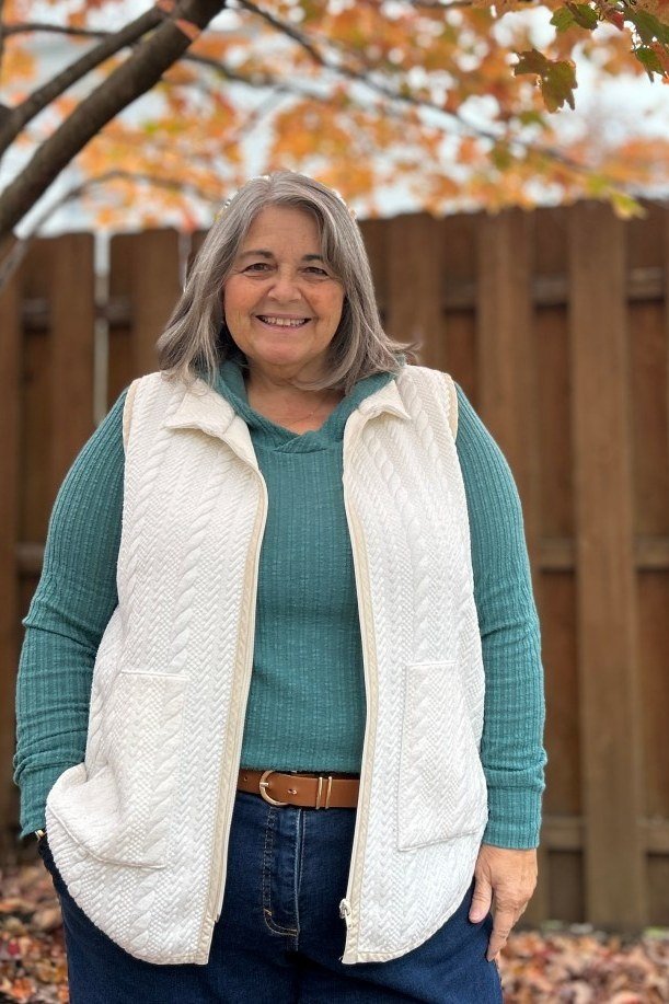 Cream quilted vest outfit for women over 60