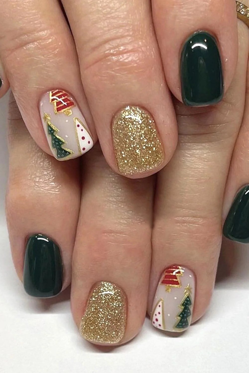 Emerald green, gold glitter and Christmas tree art mix - Christmas nail design for older women