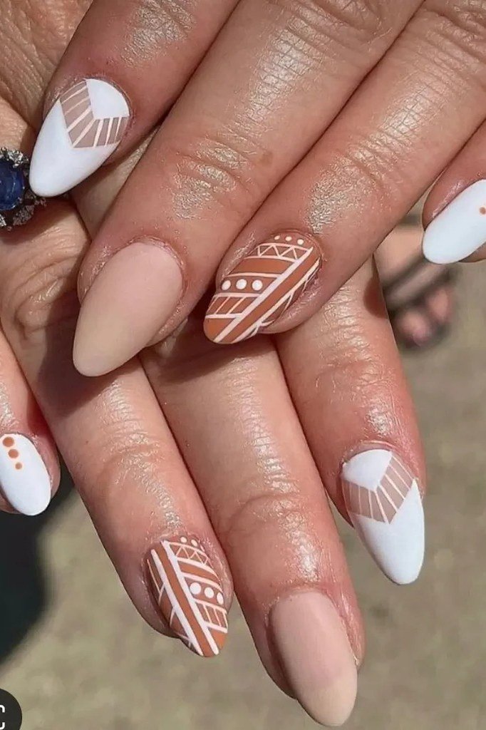 Nude nails with white tribal art accents