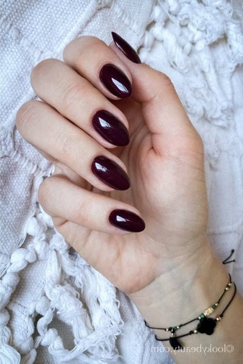 Dark plum oval nails with bracelet