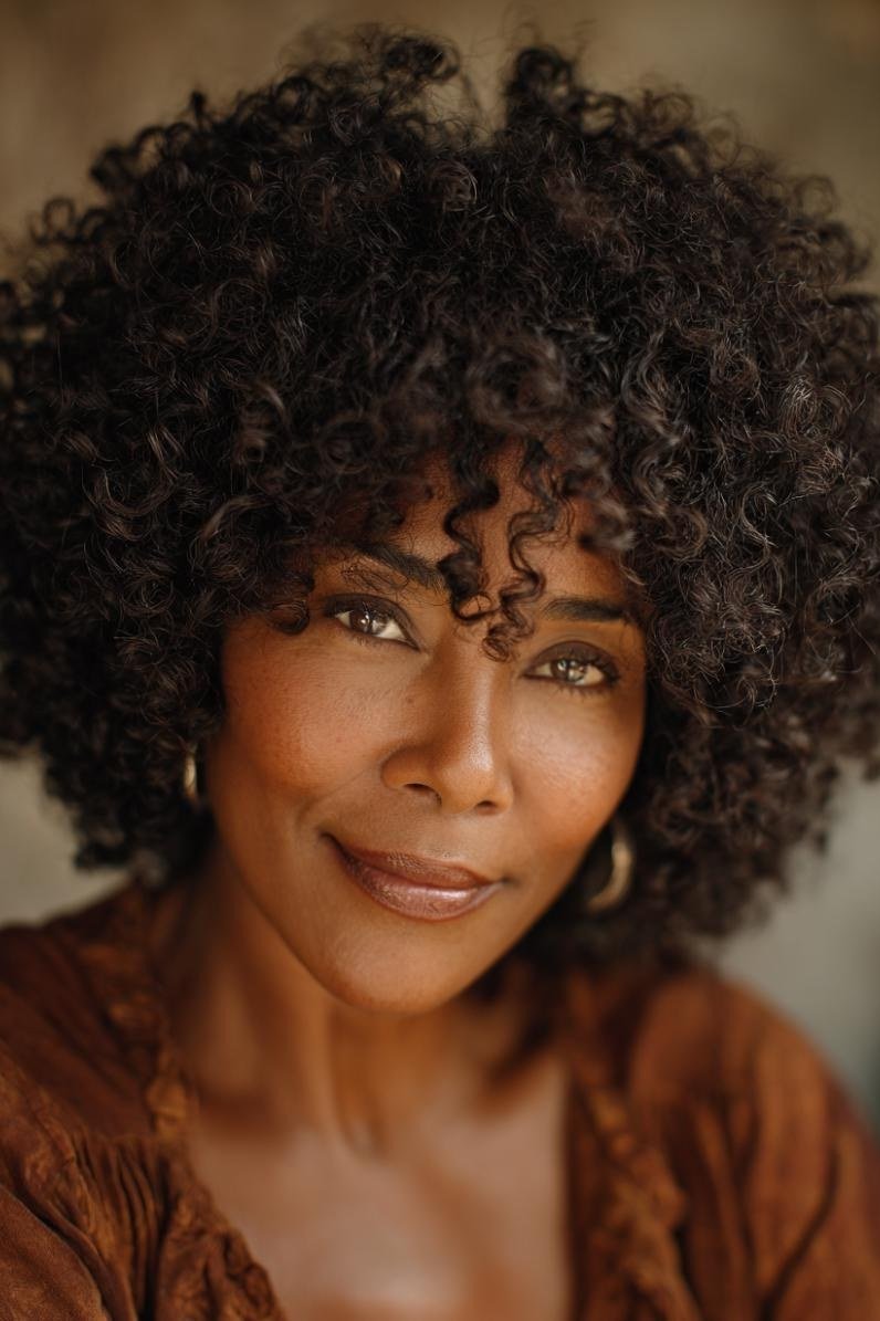 Dark voluminous curly bob haircut for women over 40
