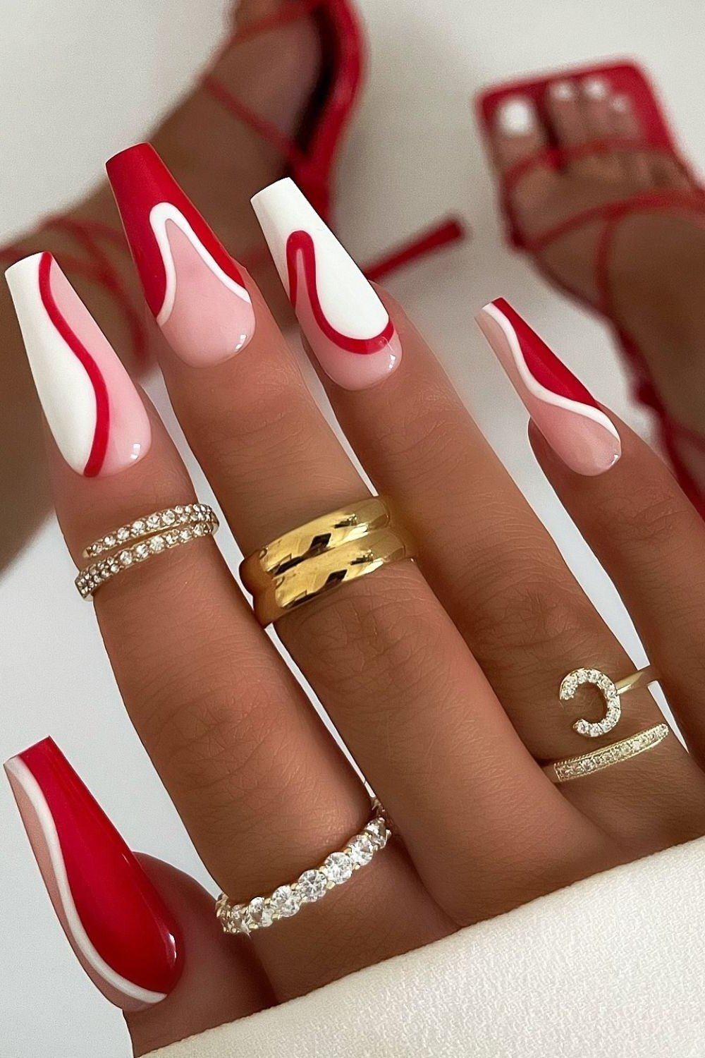 long red and white swirl christmas stiletto nails